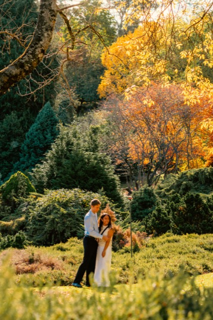 Couple embracing in golden autumn gardens in the Adelaide Hills